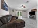 Bright living room with gray floors, vaulted ceiling, and french doors to the backyard at 145 Circle Hill Rd, Sanford, FL 32773