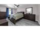 Spacious main bedroom featuring gray floors, fan, and large window at 145 Circle Hill Rd, Sanford, FL 32773