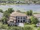 Sprawling lakefront home with a tile roof, lush landscaping, and private dock at 14700 Avenue Of The Rushes, Winter Garden, FL 34787