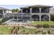 Large home showcasing the backyard with screened in pool, spa and waterfront access at 14700 Avenue Of The Rushes, Winter Garden, FL 34787