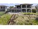 Large home showcasing the backyard with screened in pool, spa and waterfront access at 14700 Avenue Of The Rushes, Winter Garden, FL 34787