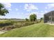 Landscaped backyard overlooking the lake with a charming wooden walkway to the dock at 14700 Avenue Of The Rushes, Winter Garden, FL 34787