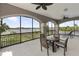 Beautiful balcony overlooking the lake features a dining table and lounge chairs for relaxing at 14700 Avenue Of The Rushes, Winter Garden, FL 34787