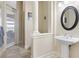 Neutral bathroom featuring a pedestal sink, elegant mirror, and glass shower door to a tiled shower at 14700 Avenue Of The Rushes, Winter Garden, FL 34787