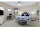 Comfortable bedroom featuring a plush bed, desk and chair, complemented by a ceiling fan with integrated lighting at 14700 Avenue Of The Rushes, Winter Garden, FL 34787