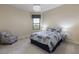 Comfortable bedroom featuring a plush bed, accent lamps and sitting chair, complemented by a modern chandelier at 14700 Avenue Of The Rushes, Winter Garden, FL 34787