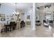 Bright dining and living room with high ceilings, marble floors, and elegant furnishings at 14700 Avenue Of The Rushes, Winter Garden, FL 34787