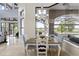 Dining area with water view, tile floor and view of covered outdoor seating area at 14700 Avenue Of The Rushes, Winter Garden, FL 34787