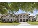 Beautiful home with mature landscaping, arched features, and a tile roof, situated on a well-maintained lawn at 14700 Avenue Of The Rushes, Winter Garden, FL 34787