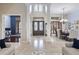 Grand foyer with soaring ceilings, marble floors, and a view into the dining room and office space at 14700 Avenue Of The Rushes, Winter Garden, FL 34787