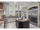 Kitchen with granite counters, stainless fridge, range and island overlooking outdoor view at 14700 Avenue Of The Rushes, Winter Garden, FL 34787