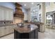 Open kitchen with island, stainless appliances, and views of the two-story living room at 14700 Avenue Of The Rushes, Winter Garden, FL 34787
