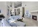 Living room with fireplace, piano and view of dining and kitchen area at 14700 Avenue Of The Rushes, Winter Garden, FL 34787