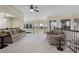 Relaxing living room features comfortable couches, side tables, and a ceiling fan for a cozy atmosphere at 14700 Avenue Of The Rushes, Winter Garden, FL 34787
