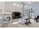 Bright living room featuring a fireplace, entertainment center, and large windows offering plenty of natural light at 14700 Avenue Of The Rushes, Winter Garden, FL 34787