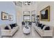Airy living room with high ceilings, marble floors, stylish seating, and views of the lake at 14700 Avenue Of The Rushes, Winter Garden, FL 34787
