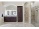 Elegant main bathroom with a walk-in shower, granite countertop vanity, and a large illuminated mirror at 14700 Avenue Of The Rushes, Winter Garden, FL 34787
