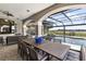 Expansive outdoor living space boasts dining, lounge areas, a pool, spa, and serene lake views at 14700 Avenue Of The Rushes, Winter Garden, FL 34787