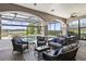 Enclosed patio with upscale outdoor seating, dining, and a pool with lake views at 14700 Avenue Of The Rushes, Winter Garden, FL 34787