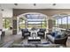 Covered patio with comfortable seating overlooks pool, spa, and serene lake views at 14700 Avenue Of The Rushes, Winter Garden, FL 34787