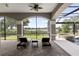 Covered patio with brick flooring has comfortable lounge chairs with lake view at 14700 Avenue Of The Rushes, Winter Garden, FL 34787