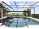 Screened in pool features attached spa and peaceful lake views at 14700 Avenue Of The Rushes, Winter Garden, FL 34787
