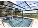 Screened pool and spa overlook the serene lake and natural landscape at 14700 Avenue Of The Rushes, Winter Garden, FL 34787