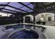 Beautiful pool with integrated spa, features a screened enclosure, and an expansive outdoor living area at 14700 Avenue Of The Rushes, Winter Garden, FL 34787