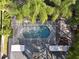 Aerial view showcasing a large screened pool, spa, and lush landscaping at 148 Oak View Cir, Lake Mary, FL 32746