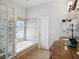Bright bathroom featuring a soaking tub with glass block window, and marble countertops at 148 Oak View Cir, Lake Mary, FL 32746