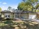 Charming single-story home featuring a well-maintained lawn, attached garage, and beautiful windows at 148 Oak View Cir, Lake Mary, FL 32746