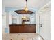 Open foyer with wood-trimmed bar area looking into a kitchen and living spaces at 148 Oak View Cir, Lake Mary, FL 32746