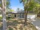 Charming single-story home featuring a well-manicured lawn, mature trees, and a two-car garage at 148 Oak View Cir, Lake Mary, FL 32746