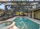 Relaxing backyard pool featuring a screened enclosure, adjacent to a spa, with an outdoor kitchen area at 148 Oak View Cir, Lake Mary, FL 32746