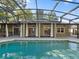 Backyard pool with a screen enclosure, perfect for outdoor entertaining and relaxation at 148 Oak View Cir, Lake Mary, FL 32746