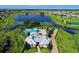An aerial view shows the clubhouse, pool, lake, and surrounding community at 14841 Porter Rd, Winter Garden, FL 34787
