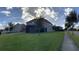Spacious backyard with a well-maintained lawn and a screened patio, perfect for outdoor relaxation and entertainment at 14841 Porter Rd, Winter Garden, FL 34787