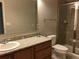 This bathroom features a granite countertop, vanity, mirror, and shower at 14841 Porter Rd, Winter Garden, FL 34787