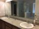 Bathroom with double sink vanity, granite countertops, large mirror and glass enclosed shower at 14841 Porter Rd, Winter Garden, FL 34787
