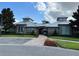 An inviting view of a modern clubhouse with well-kept landscaping, a sidewalk and ample parking at 14841 Porter Rd, Winter Garden, FL 34787