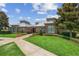Modern community clubhouse with manicured landscaping and a walkway at 14841 Porter Rd, Winter Garden, FL 34787