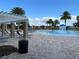 Beautiful community pool with lounge chairs, umbrellas, ' splash area and surrounding tropical landscaping at 14841 Porter Rd, Winter Garden, FL 34787