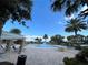Wide view of the community pool, seating, umbrellas, splash area and mature landscaping with palm trees at 14841 Porter Rd, Winter Garden, FL 34787