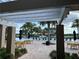 Pool-side tables under a pergola with views of tropical trees and the community swimming pool at 14841 Porter Rd, Winter Garden, FL 34787