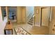 Inviting foyer featuring tile flooring, a staircase, and a view into the dining and kitchen areas at 14841 Porter Rd, Winter Garden, FL 34787