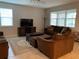 Cozy living room with comfortable seating, a large window, and a stylish area rug, perfect for relaxation at 14841 Porter Rd, Winter Garden, FL 34787