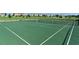 A well-maintained community tennis court with nets and view of the manicured lawns and homes in the distance at 14841 Porter Rd, Winter Garden, FL 34787