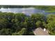 Aerial view of property with lake and treed area, providing privacy and natural beauty at 1607 Northlake Dr # 1607, Sanford, FL 32773