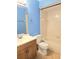 Bathroom with blue walls, vanity, toilet, and tub with tile surround at 1607 Northlake Dr # 1607, Sanford, FL 32773