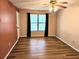 Bedroom featuring wood floors, window with curtains, and neutral walls at 1607 Northlake Dr # 1607, Sanford, FL 32773